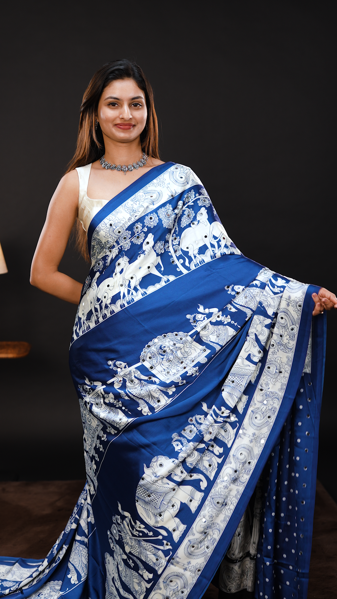 Blue Colour Semi Modal silk saree featuring Kalamkari print associate with mirror details on body, matching kalamkari print border.