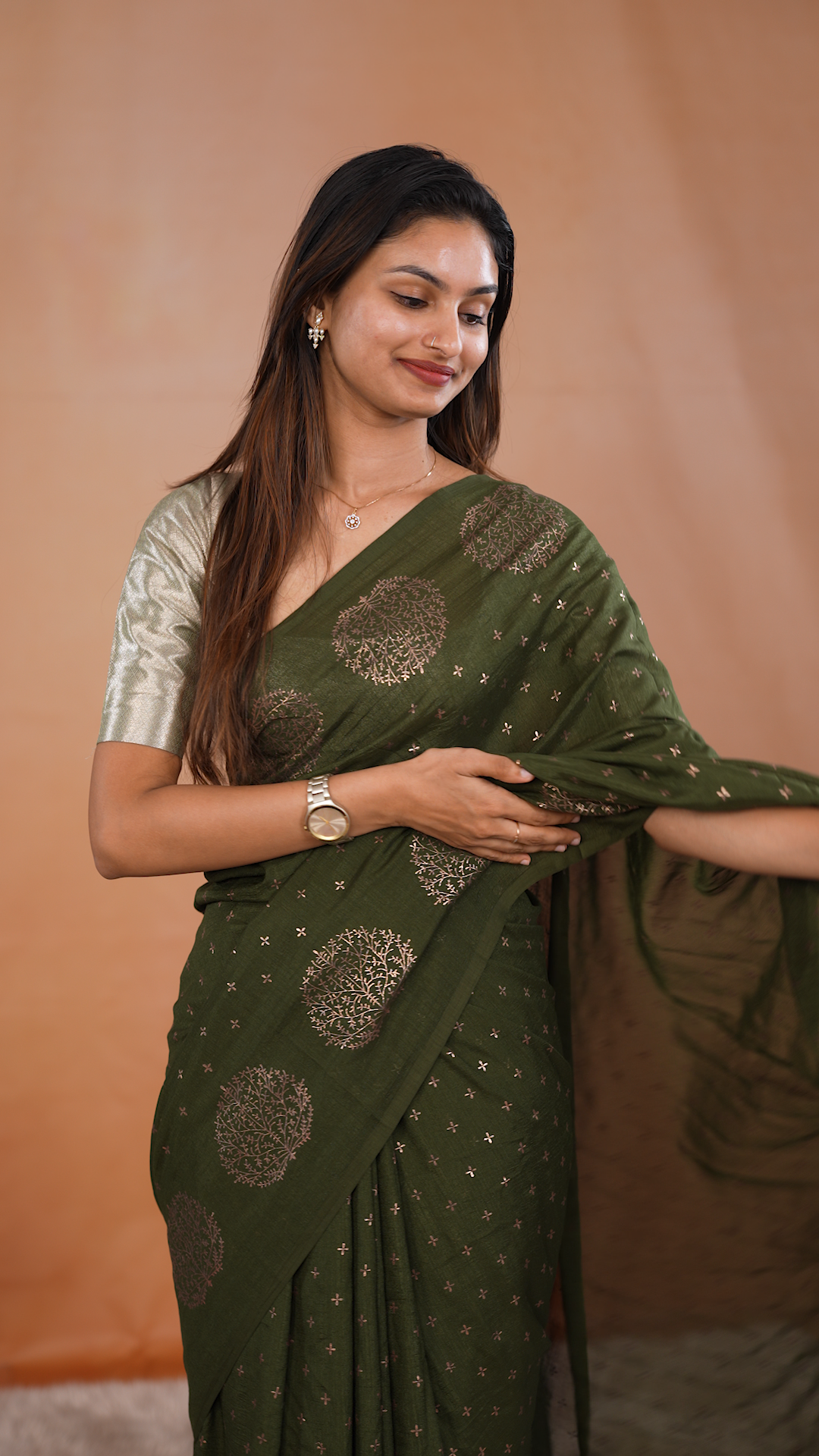 Olive colour vijithra silk saree featuring small zari details on body, Tree design border.