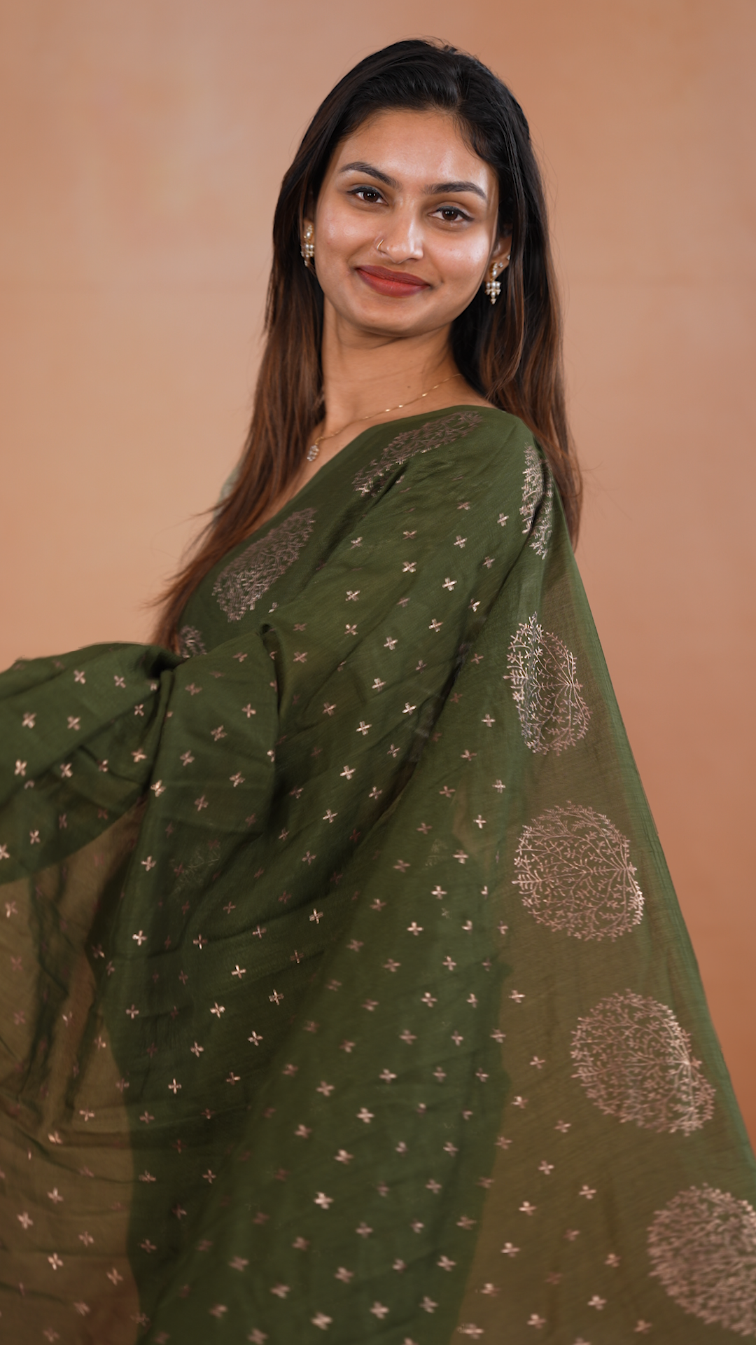 Olive colour vijithra silk saree featuring small zari details on body, Tree design border.