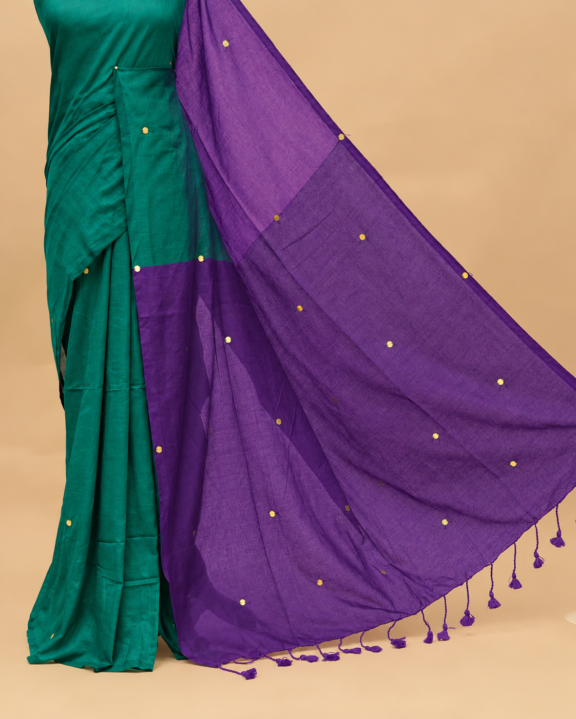 Teal and Violet coloured half and half mul cotton saree featuring elegant sequin detailing on the body, finished with a beautiful pallu adorned with tassels.
