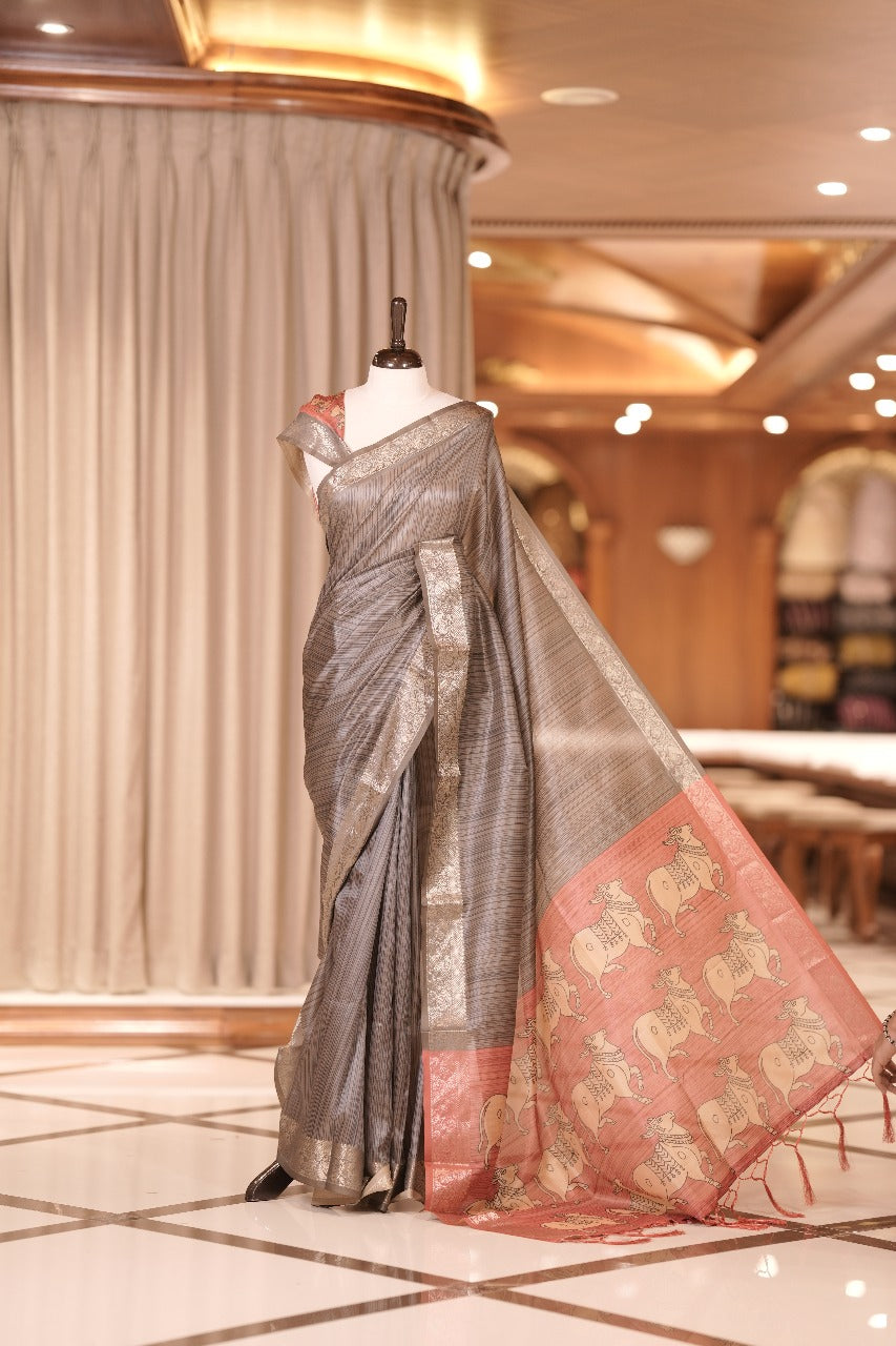 Teal blue & pink colour Dolla silk saree featuring a striped body with a matching golden zari border, The pallu showcases exquisite Kalamkari prints, complemented by a contrast printed blouse.