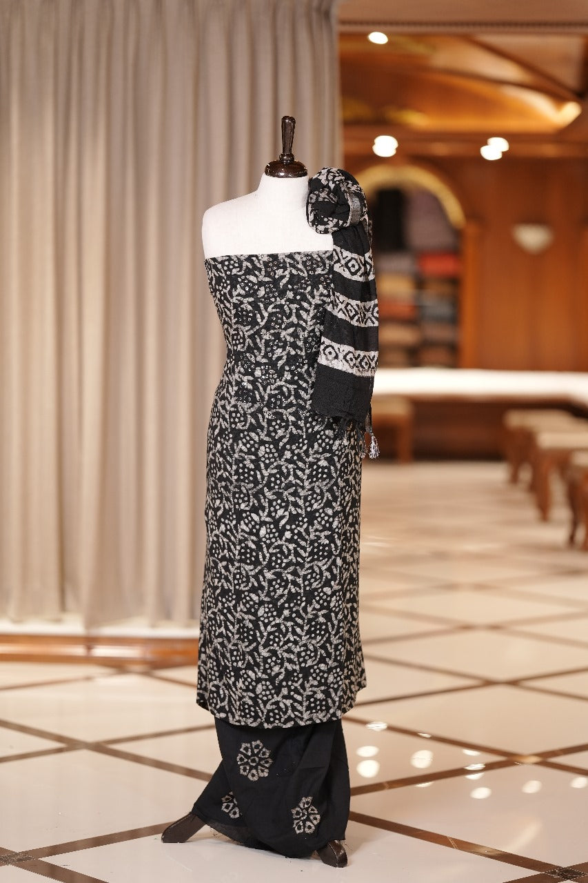 Black colour semi linen fabric featuring batik prints enhanced with thread and sequin work, paired with a side printed dupatta and a block printed bottom