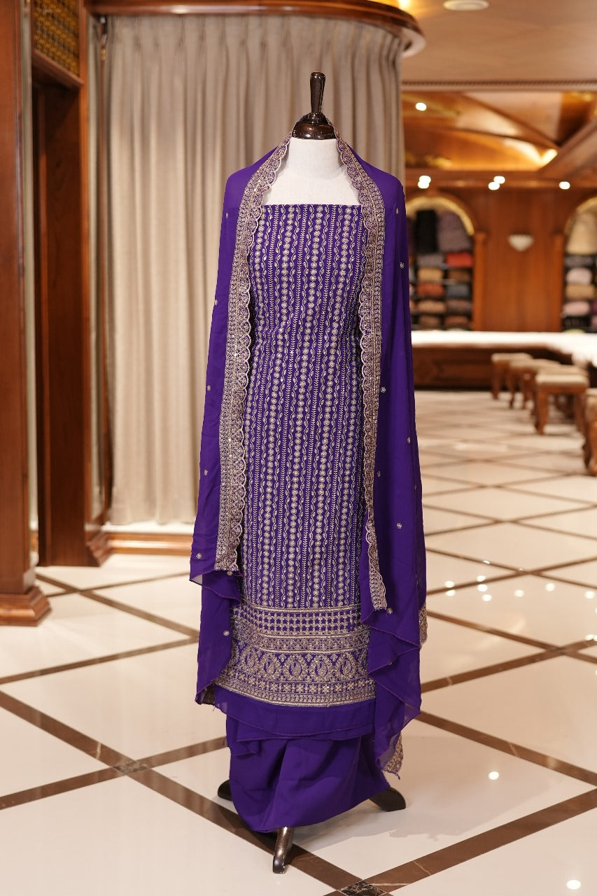 Violet Colour Georgette top adorned with gold zari and sequin work, paired with a scallop bordered dupatta featuring golden zari embroidery and a plain bottom.