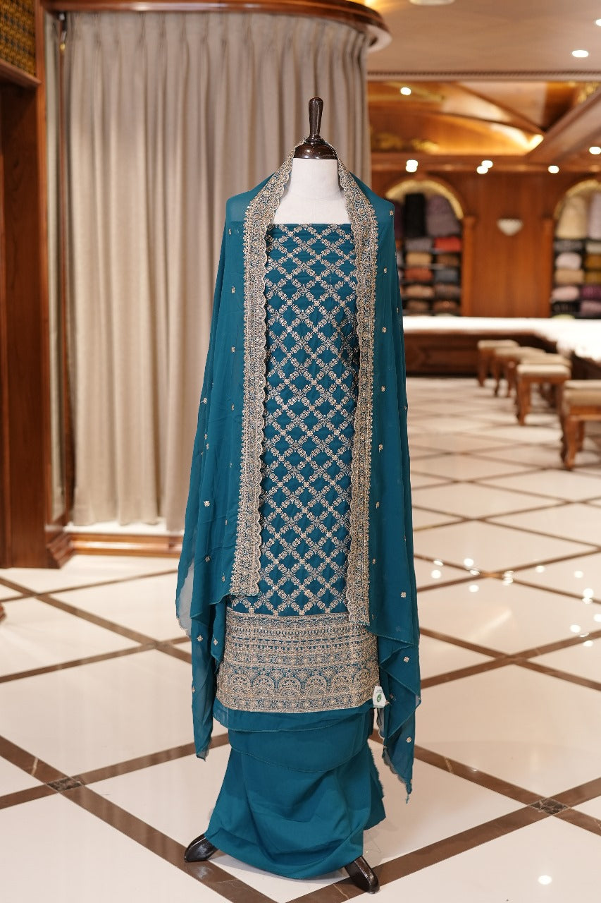 Sapphire Blue Colour Georgette top adorned with gold zari and sequin work, paired with a scallop bordered dupatta featuring golden zari embroidery and a plain bottom.