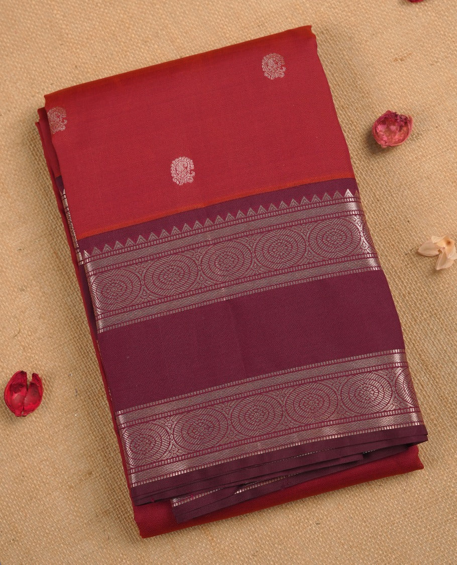 Maroon & brown double shade colour soft silk saree adorned with delicate woven motifs on the body, complemented by a contrast burgundy colour woven pallu with intricate detailing light gold zari border & Comes with a matching blouse piece.