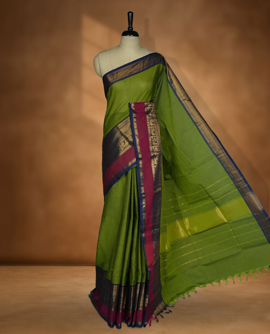 Green colour chettinad cotton saree featuring plain body, paired with a Navy Blue colour traditional gold zari border paired with matching blouse.