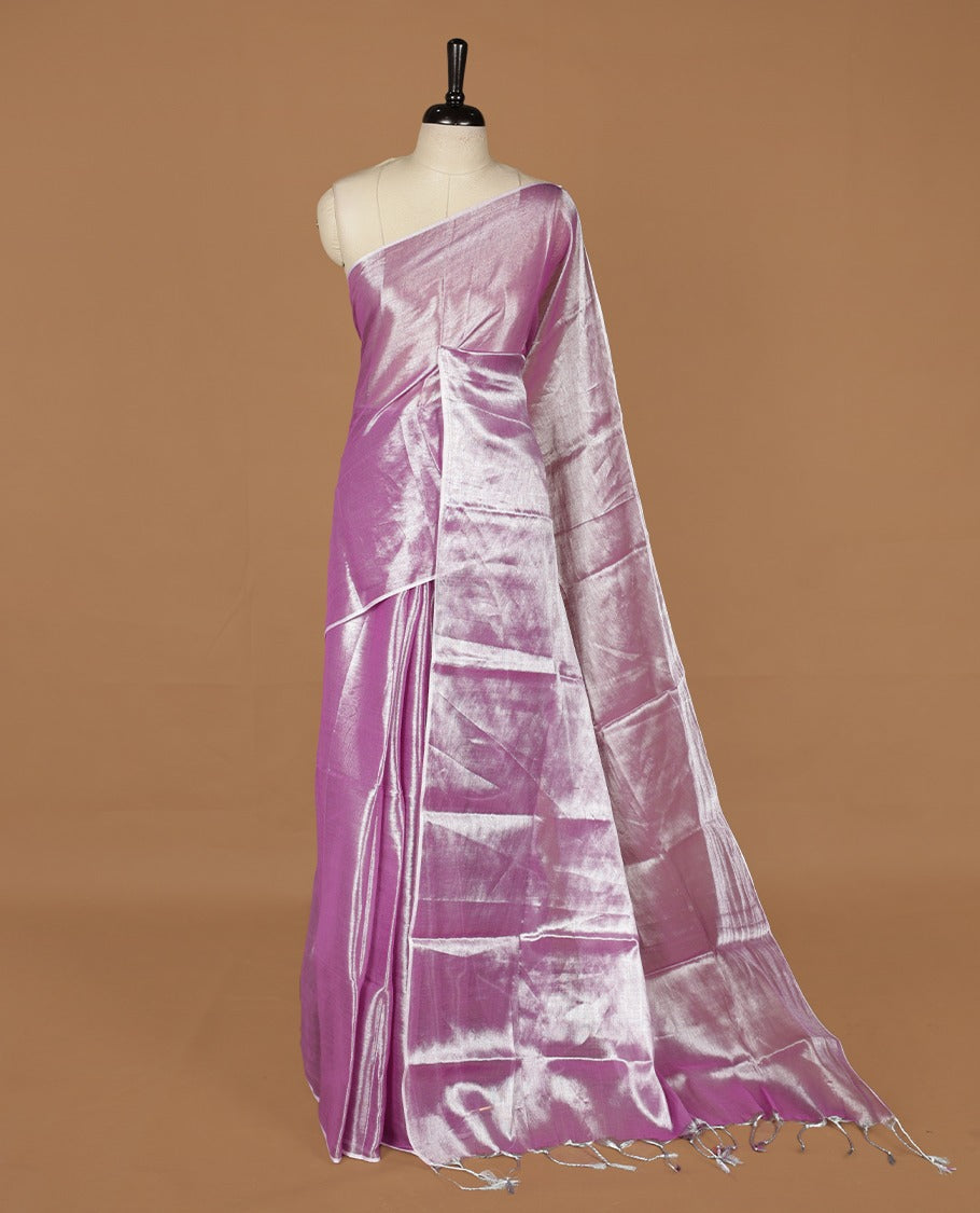 Lavender colour semi tissue saree featuring an elegant plain body, designed without a border and comes without a blouse piece.