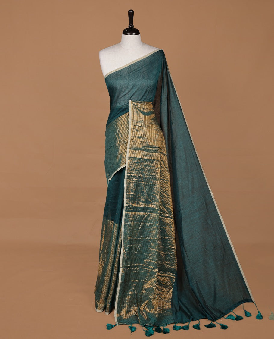 Green mul cotton saree with an elegant half and half design, blending plain fabric with a contrasting tissue finish, without blouse piece.