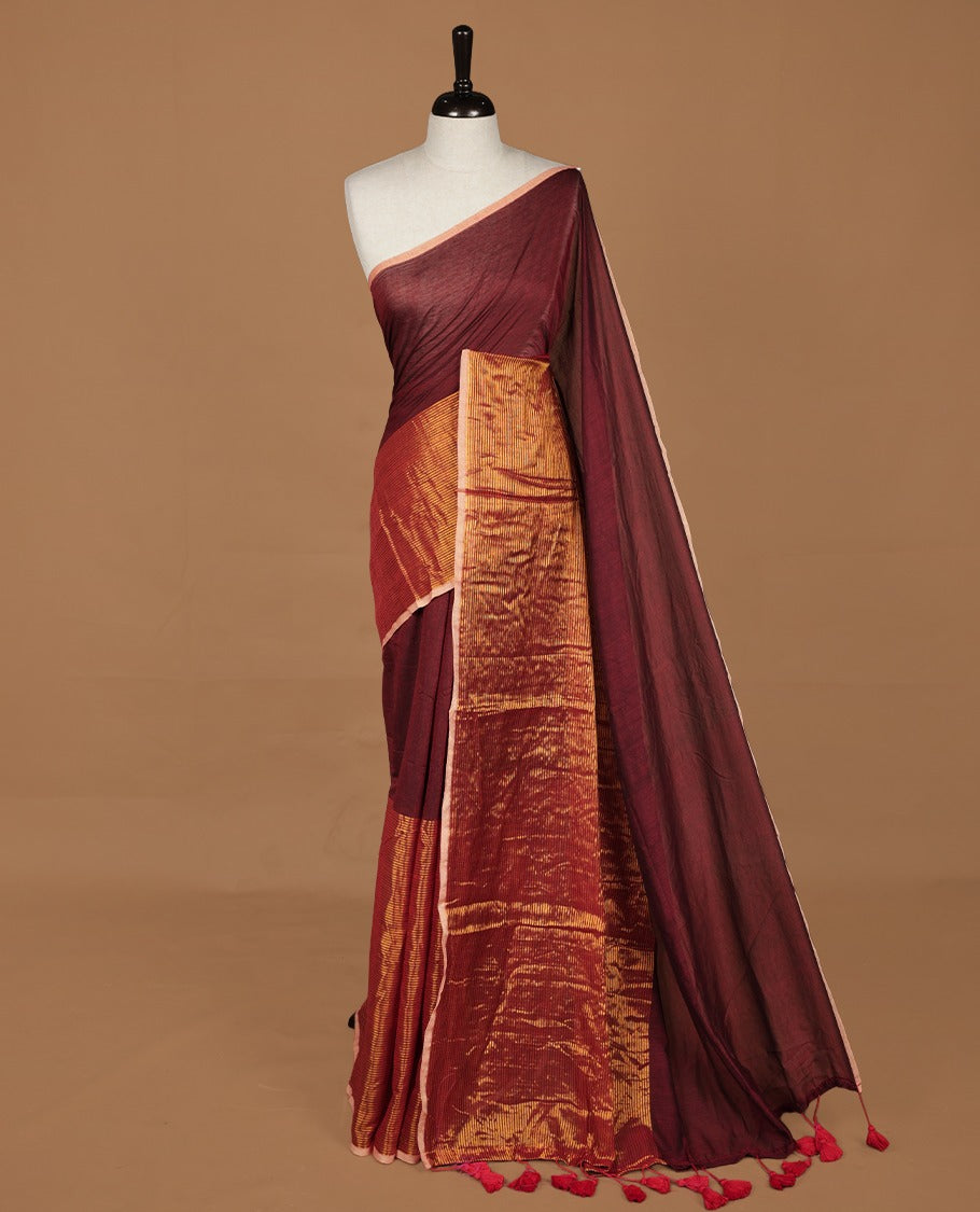 Maroon mul cotton saree with an elegant half and half design, blending plain fabric with a contrasting tissue finish, without blouse piece.