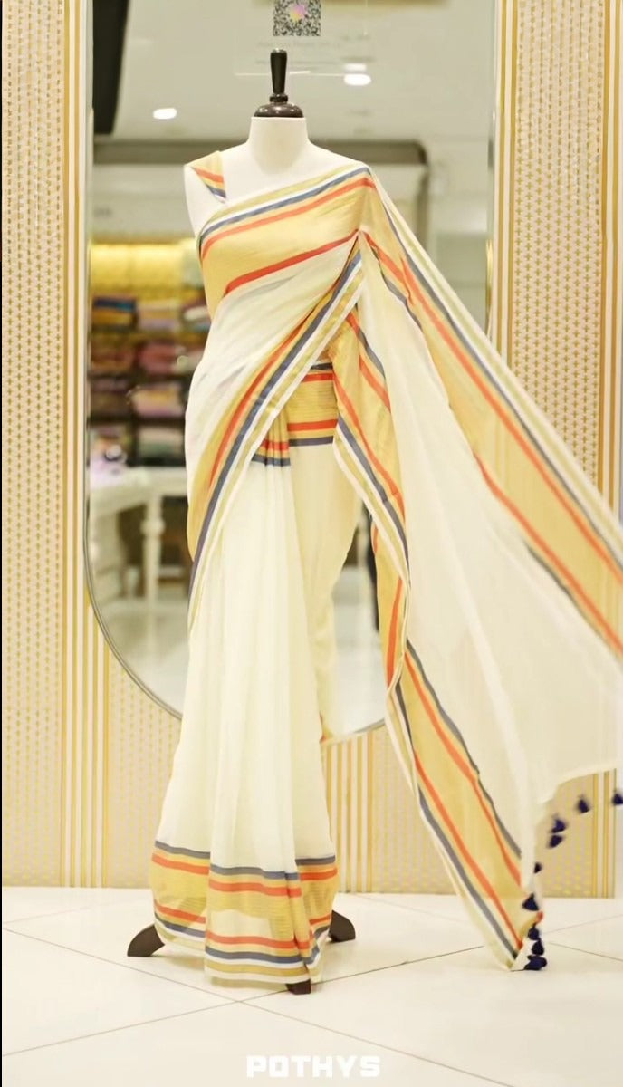 off white color mul cotton saree featuring elegant plain body, complemented by multicolour border, tessels at pallu end.