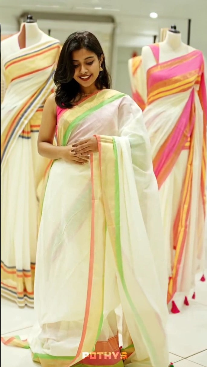off white color mul cotton saree featuring elegant plain body, complemented by multicolour border, tessels at pallu end.