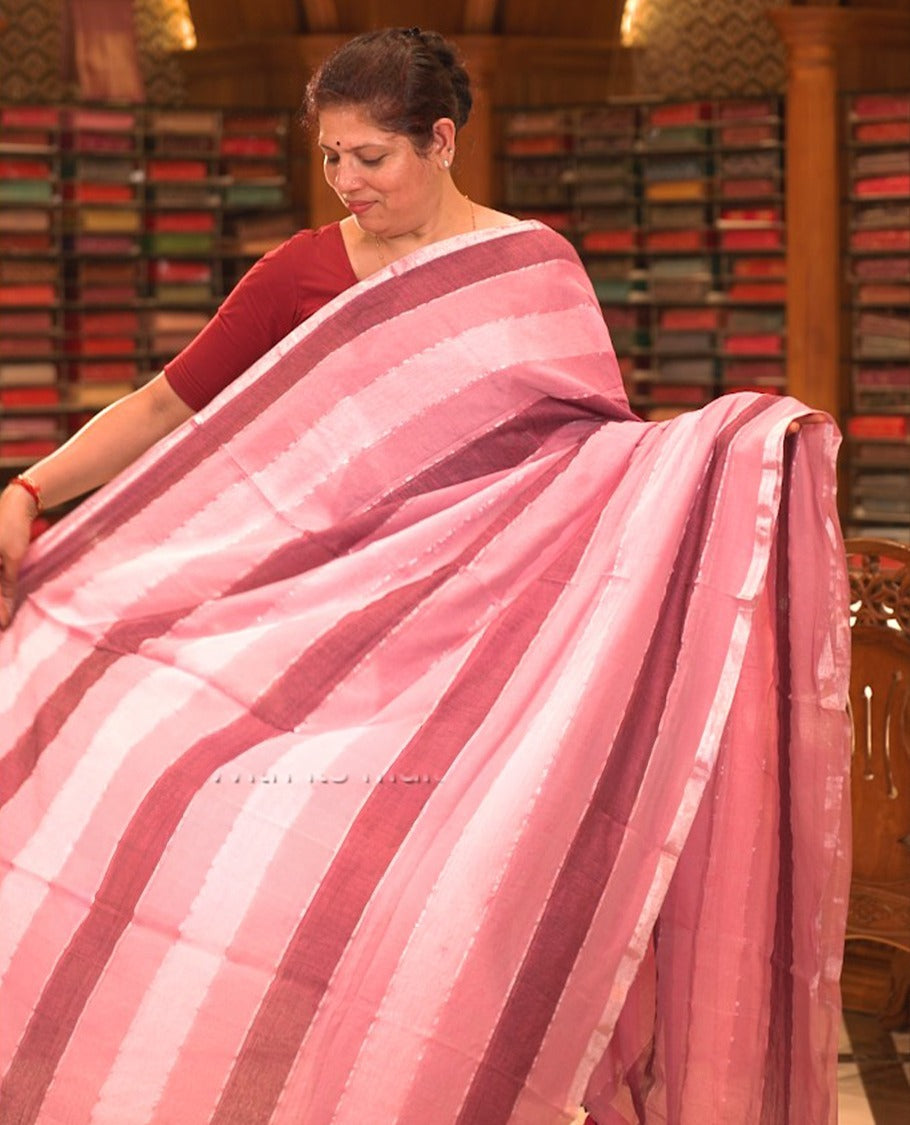 Pink colour Mul cotton saree featuring stripes on body, without border, without blouse piece.