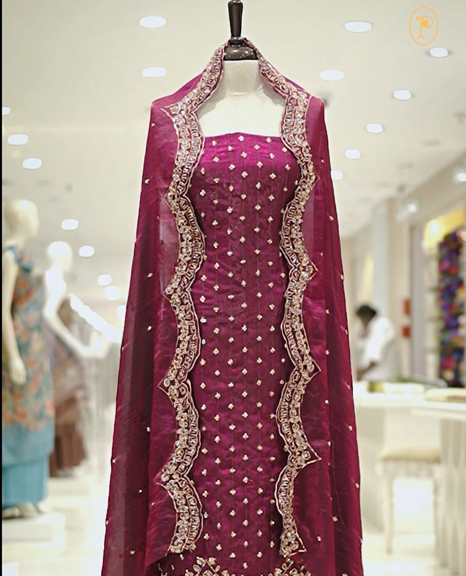 Purple colour Fenty silk salwar material highlighting gold sequins on body and scalp design on border, matching dupatta with scalp design, paired with matching bottom.
