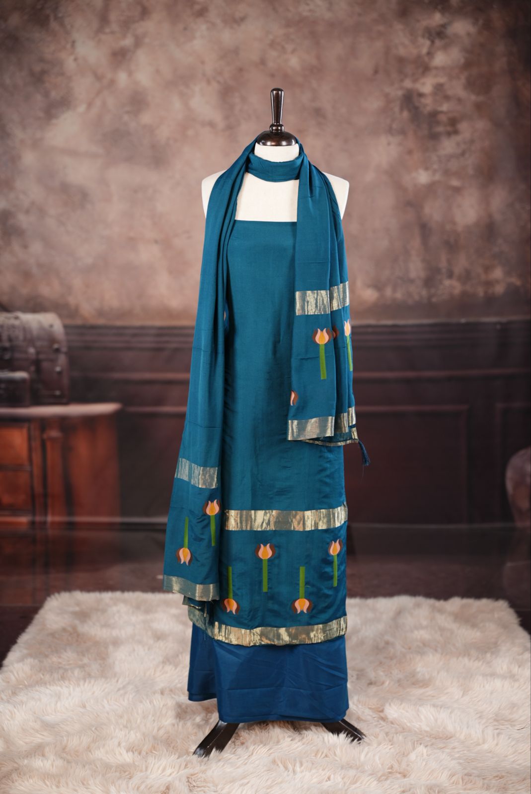 Peacock Blue colour Semi silk Salwar Material Featuring Traditional Gold Kasav With Lotus print border, paired with matching Semi silk Dupatta & bottom.