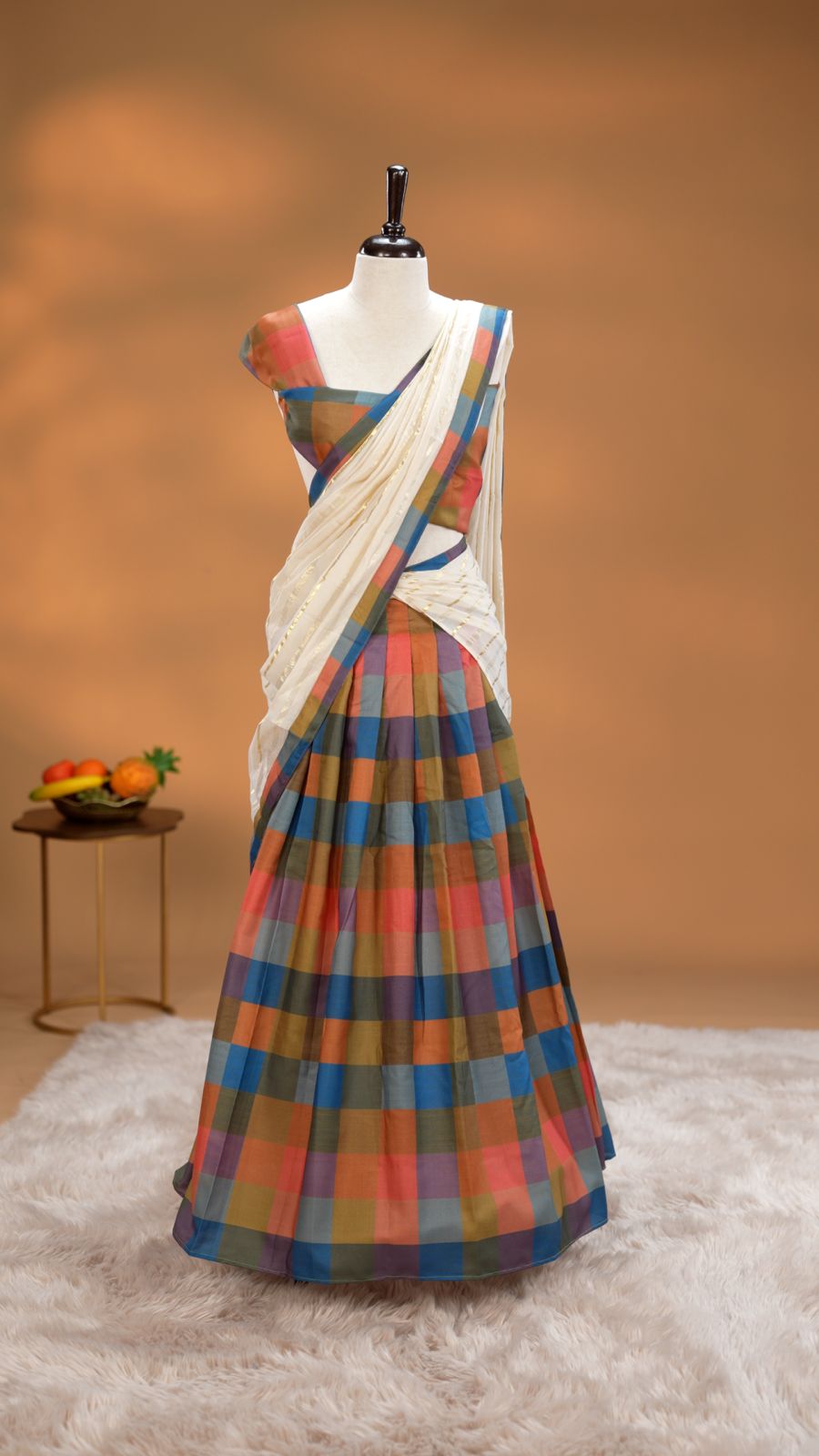 Blue, Green, Olive & orange colour Dhavani set featuring Check pattern skirt, comes with Matching blouse piece, Paired with white Dupatta With gold zari strip & Madras check border.