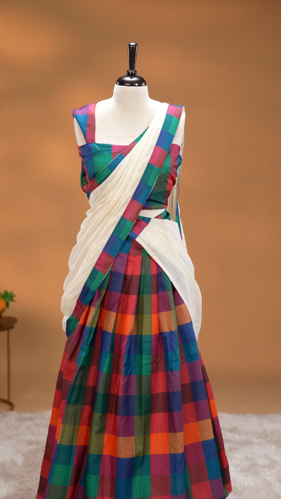 Yellow, Blue, Pink & Lavender colour Dhavani set featuring Check pattern skirt, comes with Matching blouse piece, Paired with white Dupatta With gold zari strip & Madras check border.