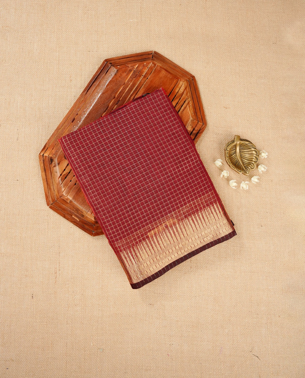 Dark maroon colour Maheshwari cotton saree, gold zari small checks on body, complement self colour gold zari temple design border comes with matching blouse.