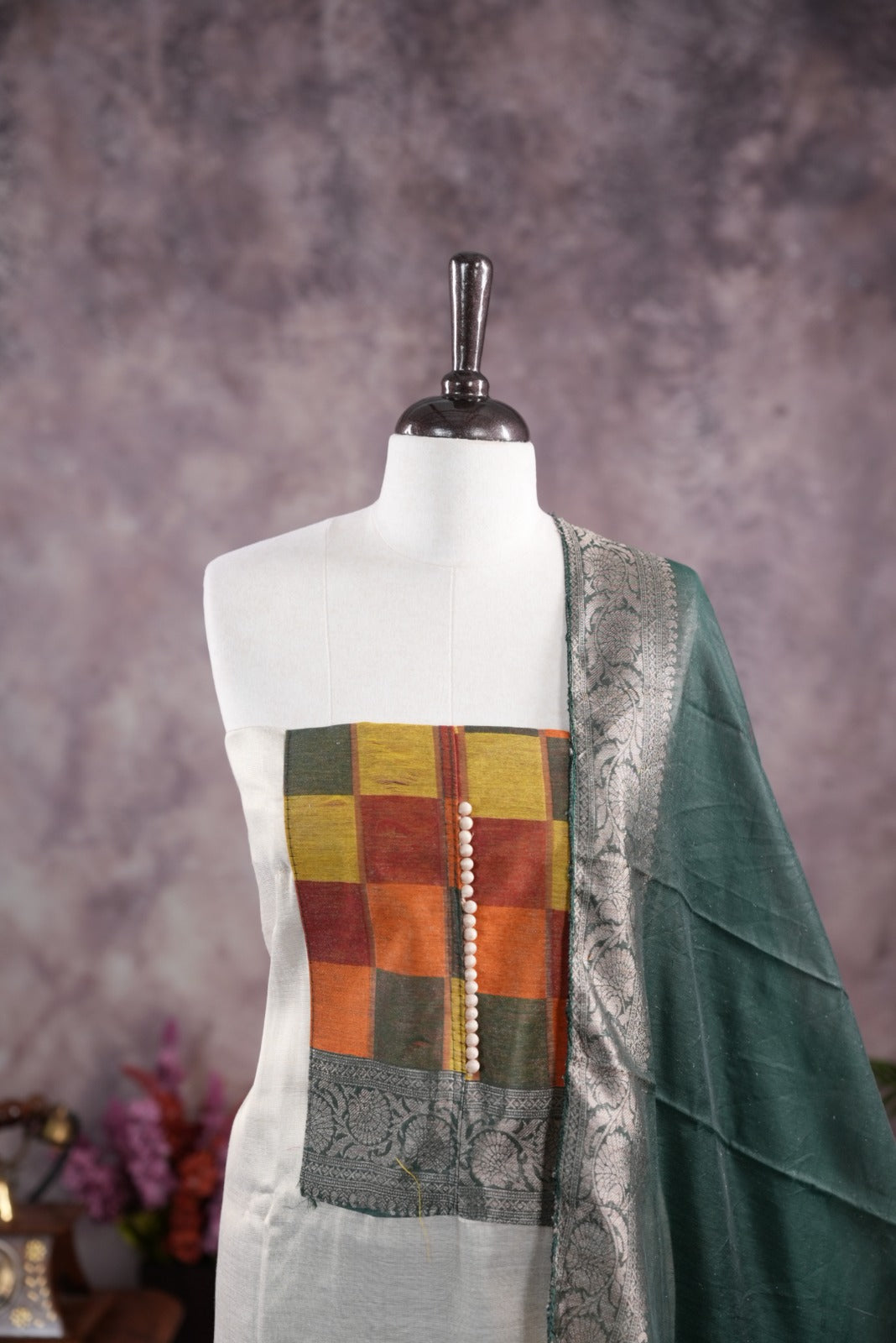 Green colour tissue Madras check salwar material featuring a plain body with a classic Kasavu border, paired with a Chanderi dupatta adorned with a matching Kasavu border and a Shantoon fabric bottom.