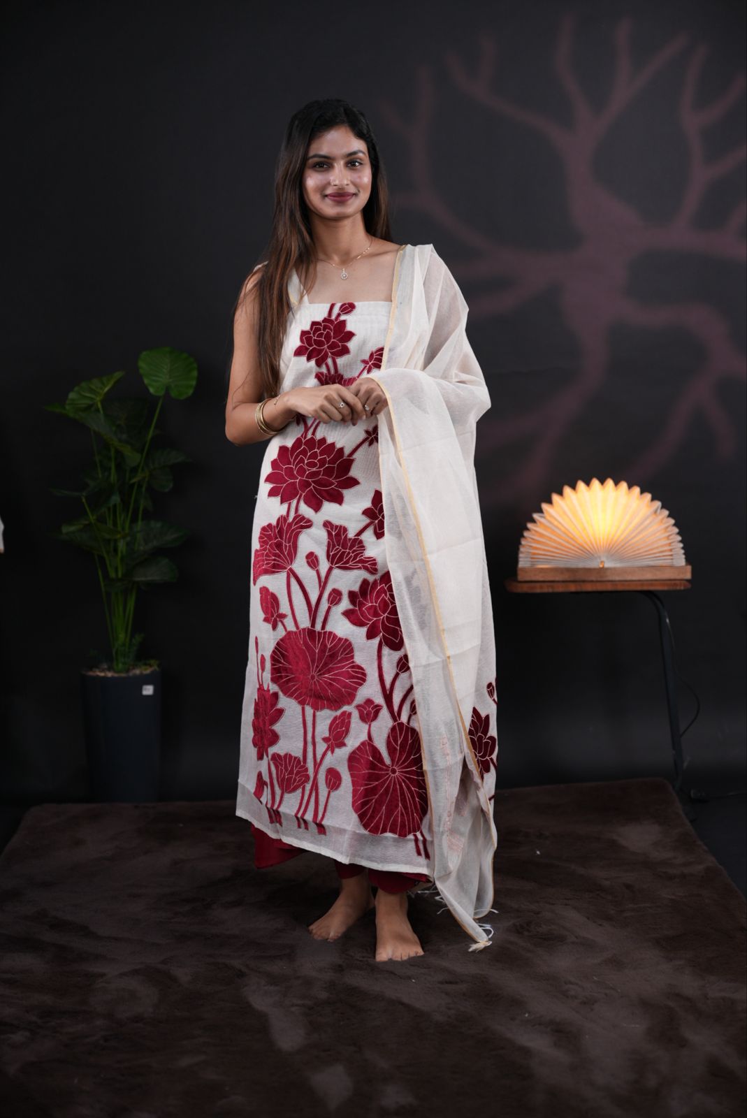 White net kota salwar material featuring Reddish Maroon Velvet applique work on body, paired with matching colour santoon bottom, elegant dupatta.