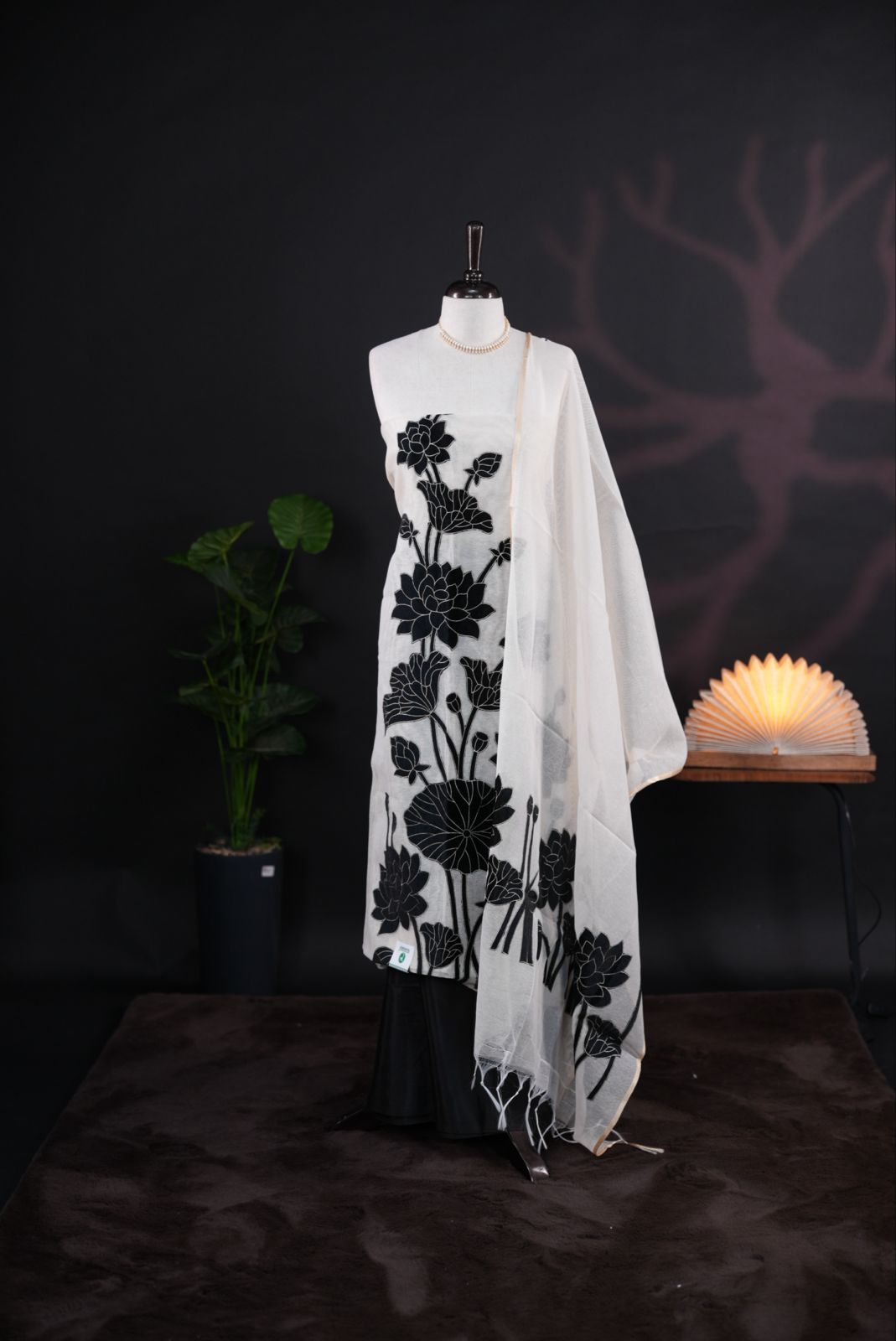 White net kota salwar material featuring Black Velvet applique work on body, paired with matching colour santoon bottom, elegant dupatta.