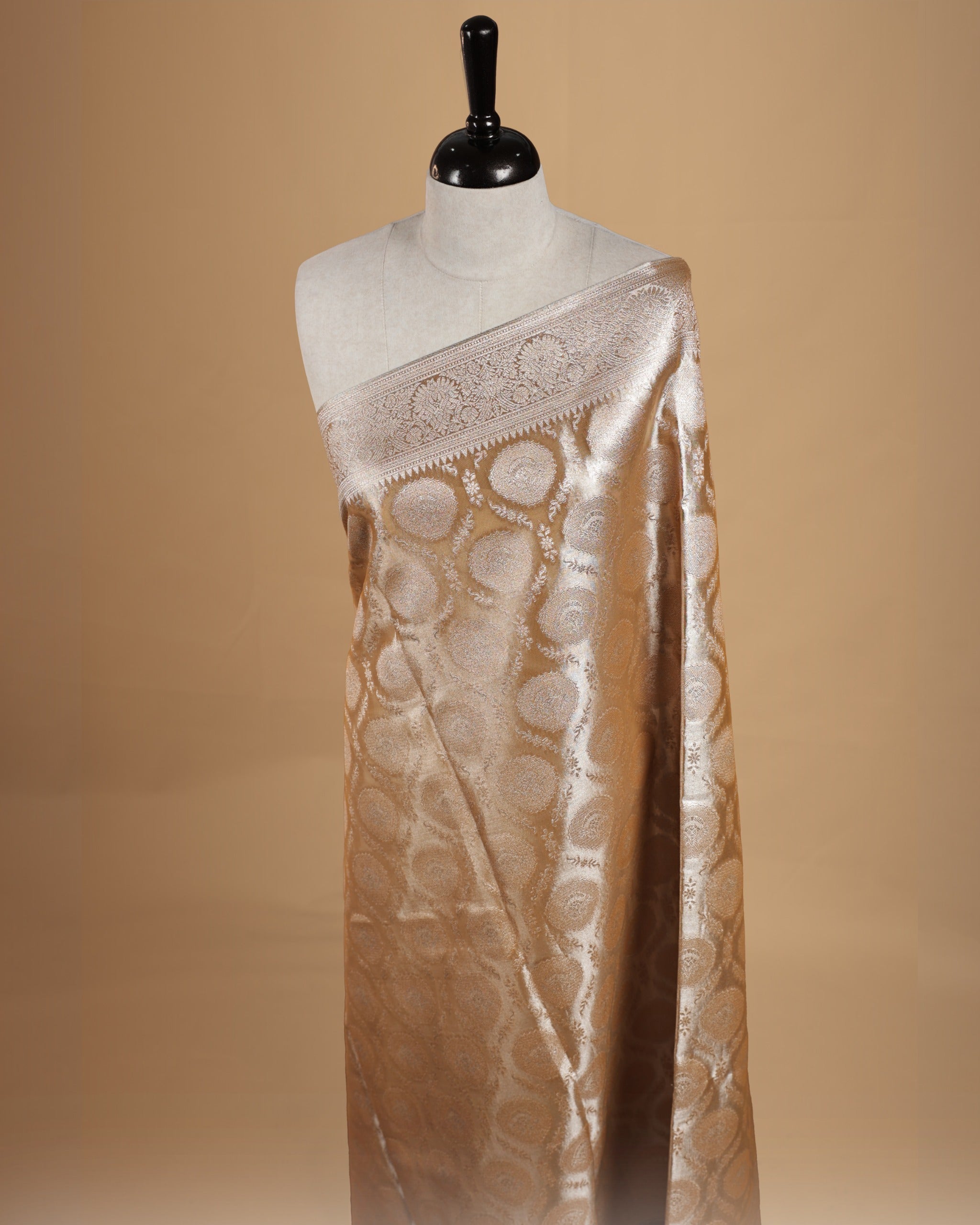 Pastel yellow colour semi tissue silk saree featuring floral zari motifs on body, complemented by gold zari traditional border, paired with matching blouse piece.