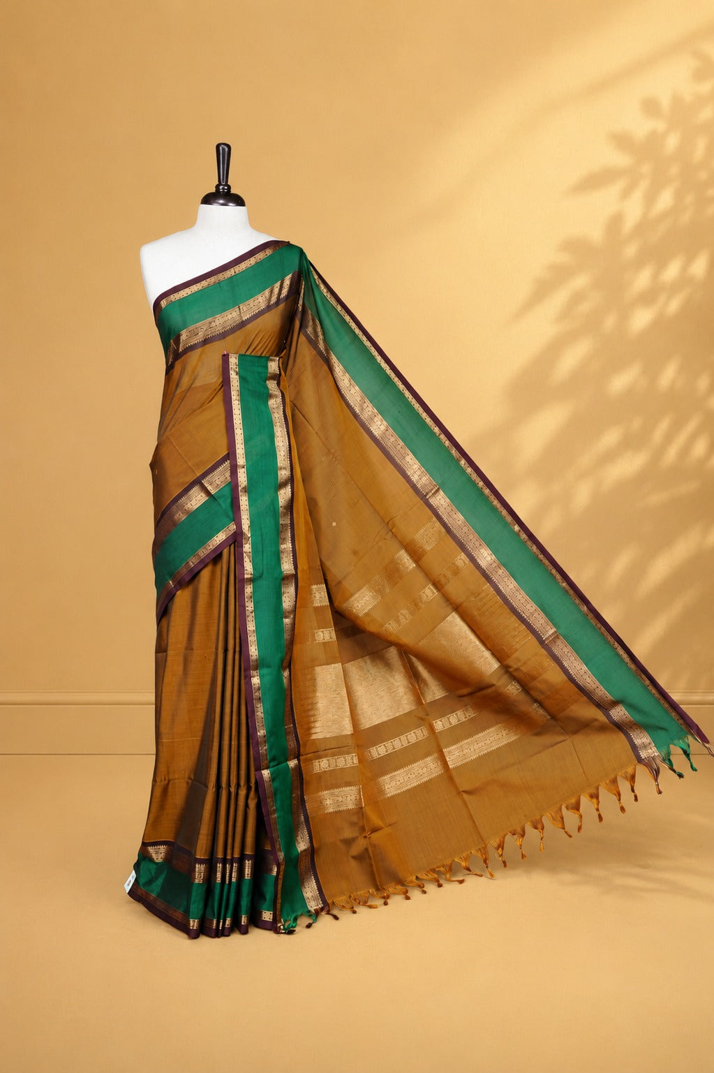 Olive colour Chettinad Silk cotton saree featuring Elegant body, complemented by Contrast Green & Chocolate colour with Gold zari border, paired with matching blouse piece.