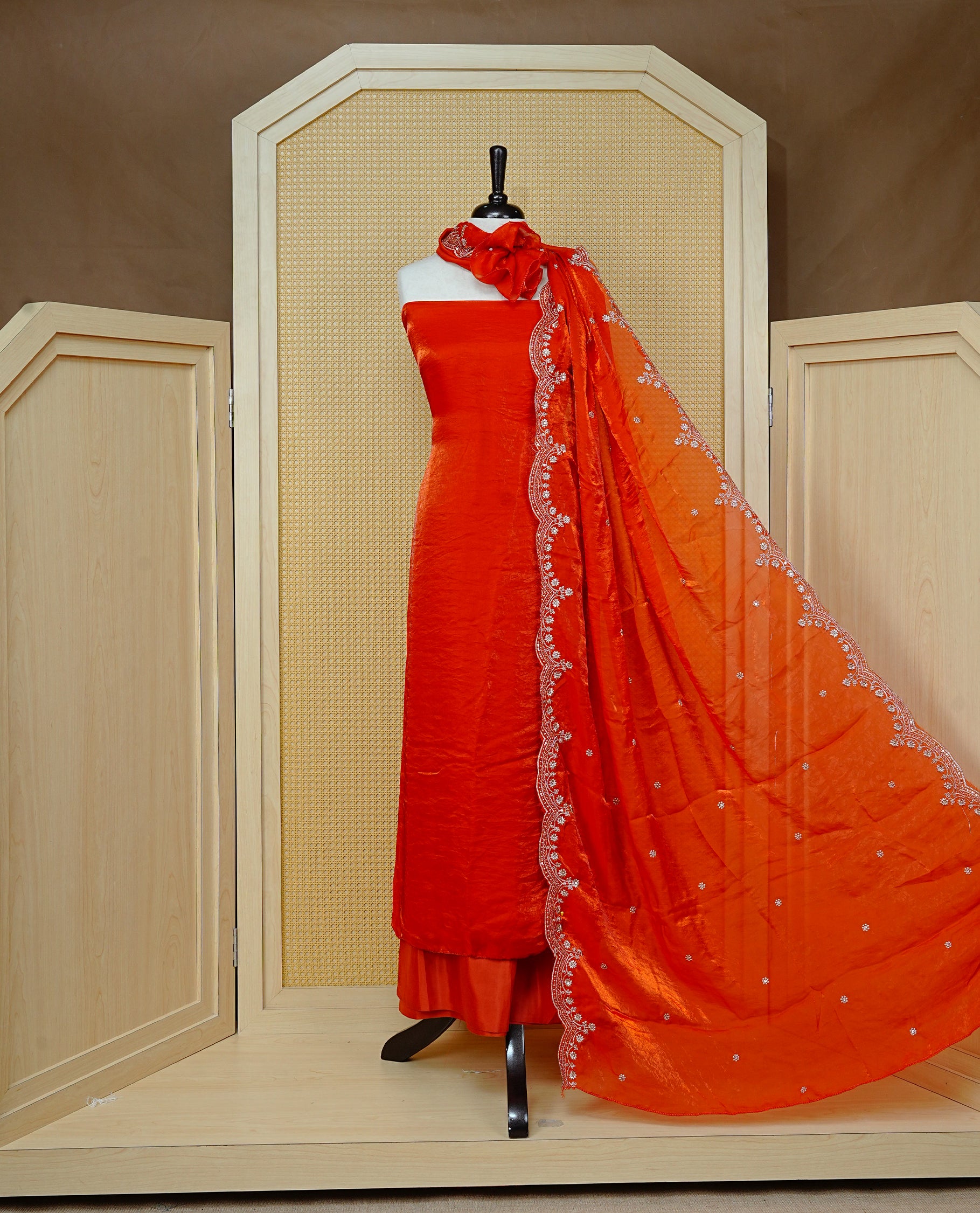 Orange colour Fendy silk salwar material With Elegant plain body with lining, Comes with santoon bottom, Fendy silk dupatta With Floral buttas & Scalp Border.