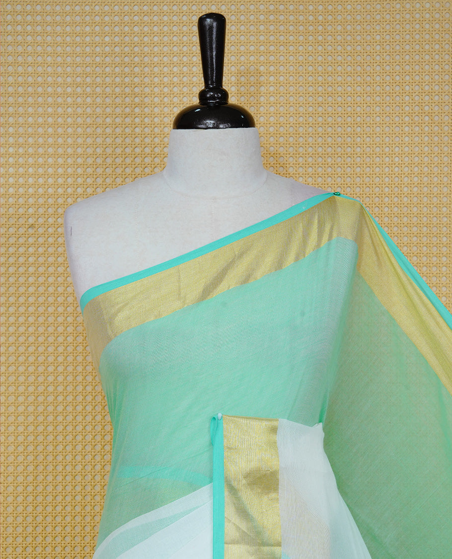 Pastel Mint with White Dual colour Mul cotton saree featuring Half & Half Dual Tone Plain Body, Complemented by Gold tissue Border & pallu.