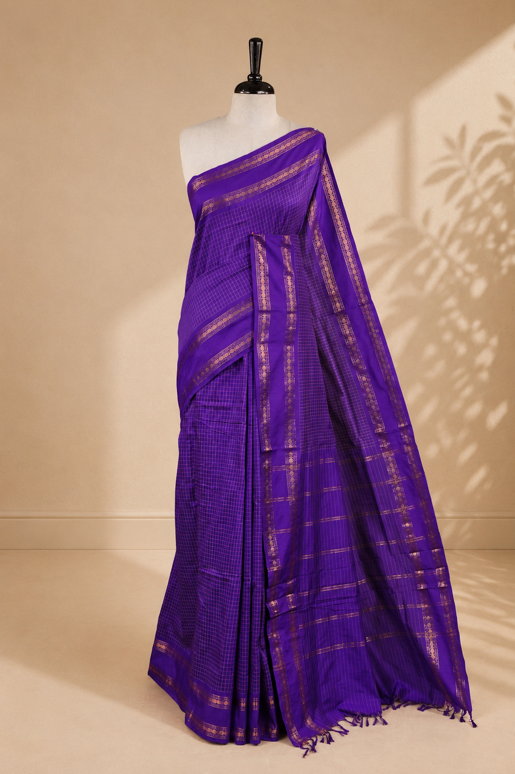 Indigo colour kalyani cotton saree featuring gold zari check pattern on body, complemented by Self colour with Antique zari border, paired with matching blouse piece.