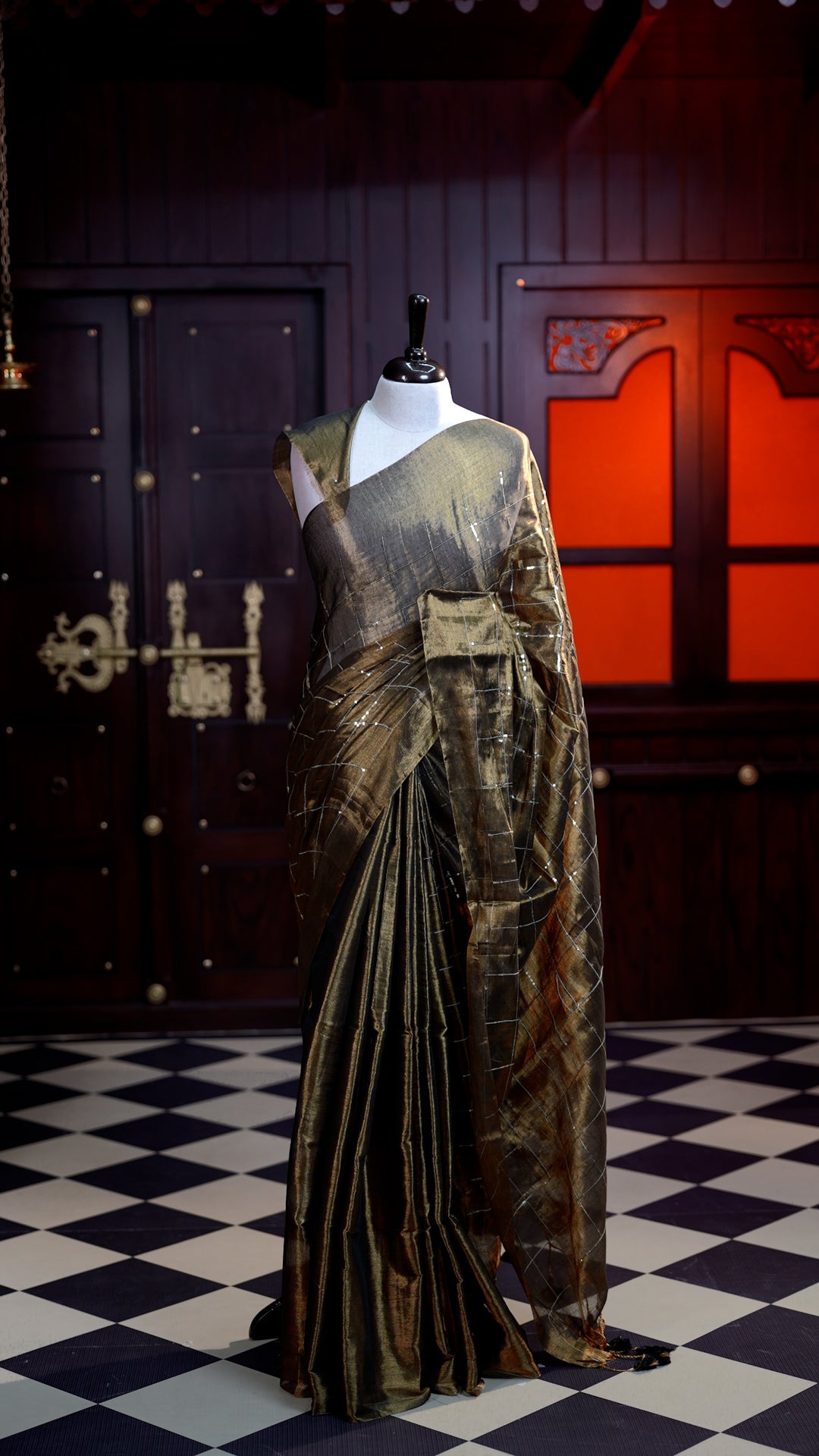Brown colour Semi Tissue Material saree with on all-over check design with silver sequin work on body, comes with a self blouse and a self pallu.