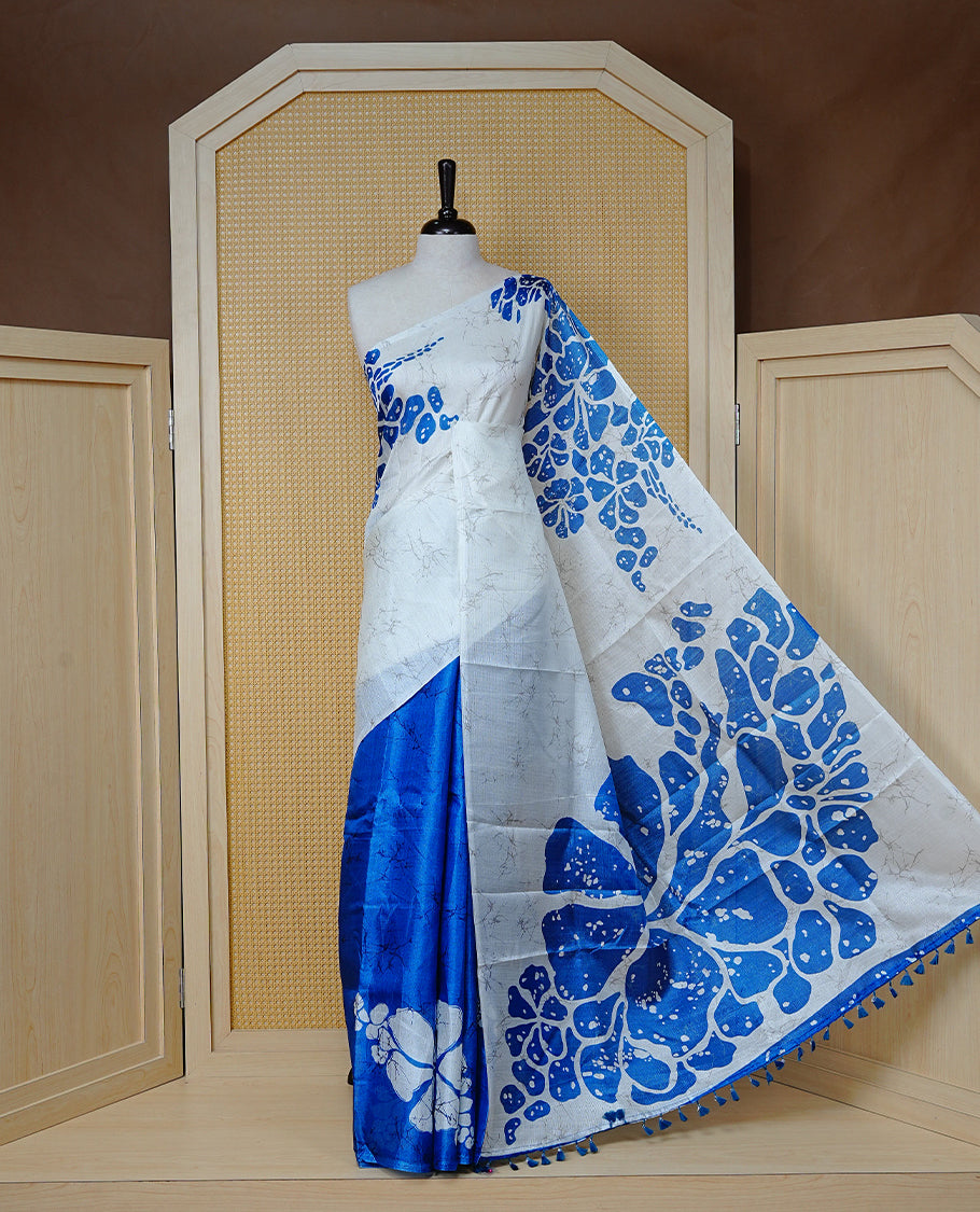 Blue With white colour Semi khadi silk saree featuring floral Print on body, enhanced with contrast Printed pallu, Comes with matching blouse piece.