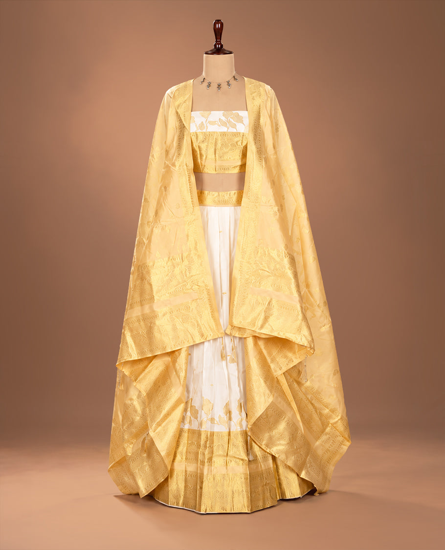 Off white colour Semi stitched dhavani set featuring Gold zari Buttas with Contrast gold colour border skirt, paired with matching blouse & dupatta.