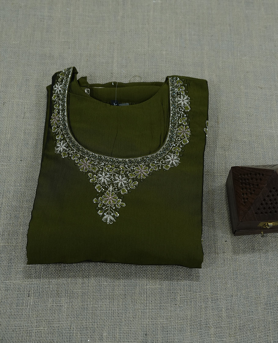 olive green colour green salwar suit featuring intricate silver thread embroidery around the neckline. A graceful choice for celebrations and special occasions.