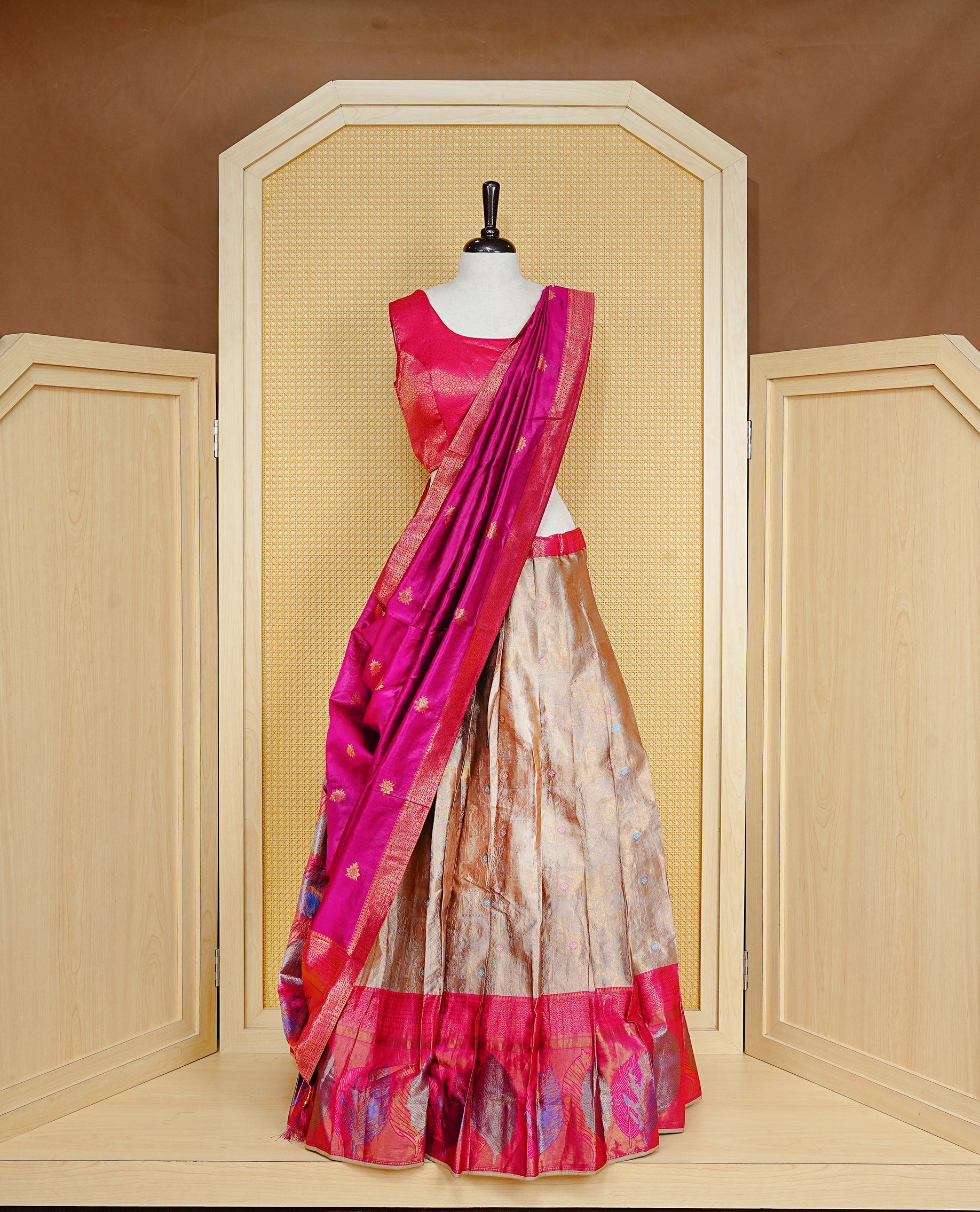 Cream colour Dhavni set Featuring cream Skirt with Gold zari Pattern and Contrast pink colour border, paired with Stitched Blouse & Elegant Dupatta.