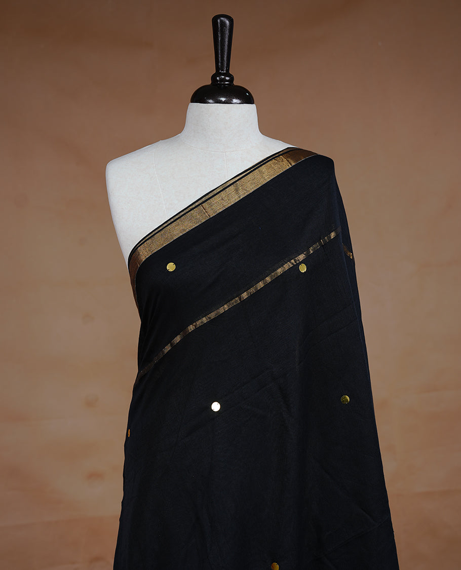 Black colour Mul Cotton saree featuring a plain body with sequin detailing, highlighted by a small gold colour border,without blouse piece.