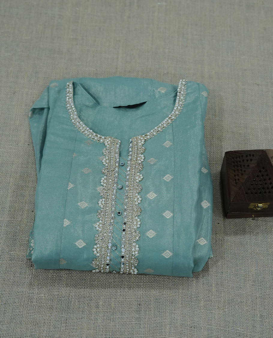 light green colour salwar suit featuring intricate silver thread embroidery around the neckline. A graceful choice for celebrations and special occasions.