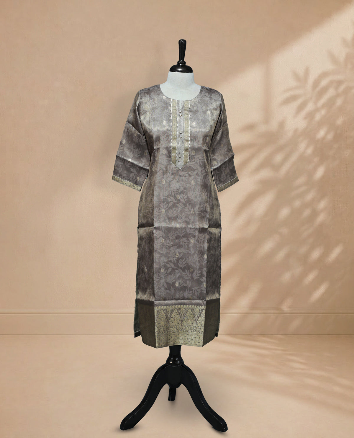 Grey colour Kurti featuring an intricate floral pattern, a round neckline adorned with detailed Stone & thread work, and 3/4 sleeves Design