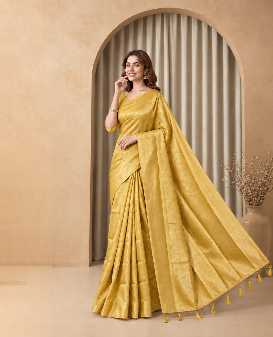 Mustard Yellow Colour Elite Soft Silk Saree with silver zari leaf motifs on the body, a self Banarasi silver zari border and brocade pallu, Paired with a blouse Piece featuring small silver zari buttas.