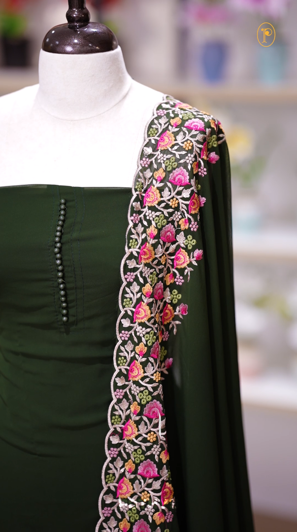 Green colour Chiffon churidhar material featuring a plain top adorned with delicate beads work on the neckline, paired with a plain bottom, Highlighted by a dupatta with floral embroidery, sequins, and scalloped edges.