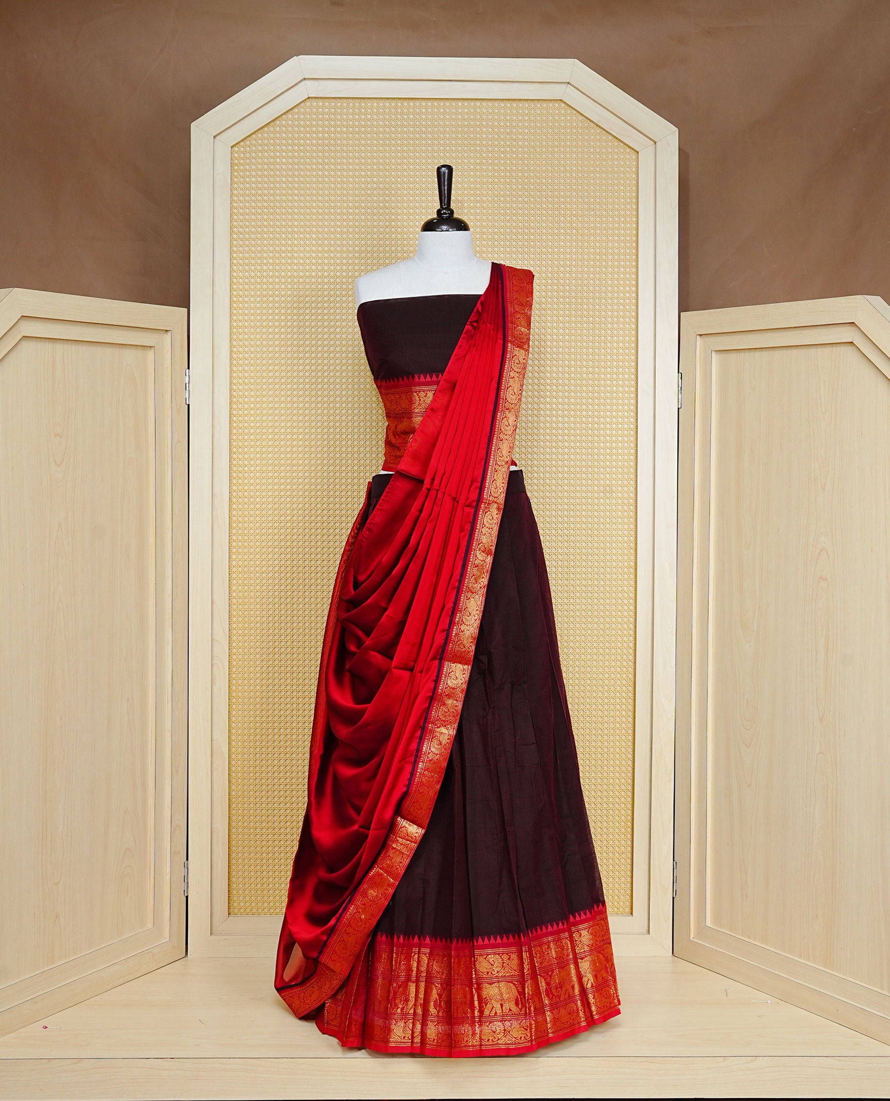 Dark chocolate colour Semi Stitched Dhavni set Featuring Dark Chocolate Skirt With Contrast Red colour with Zari border, paired with UnStitched Blouse & Elegant Dupatta.