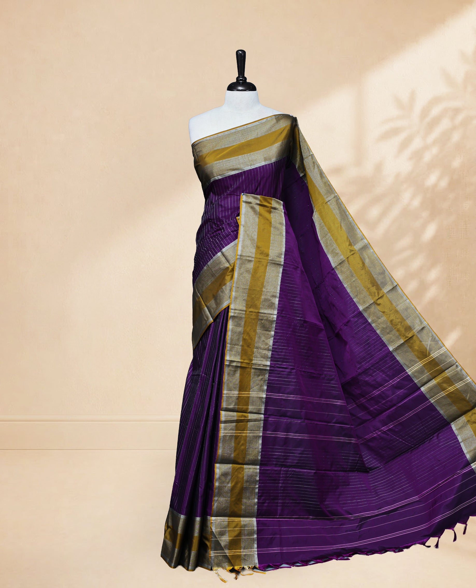 Purple colour Semi Silk Saree Featuring Gold zari Stripes on body, complemented by Contrast Border Detailing, comes with matching blouse piece.