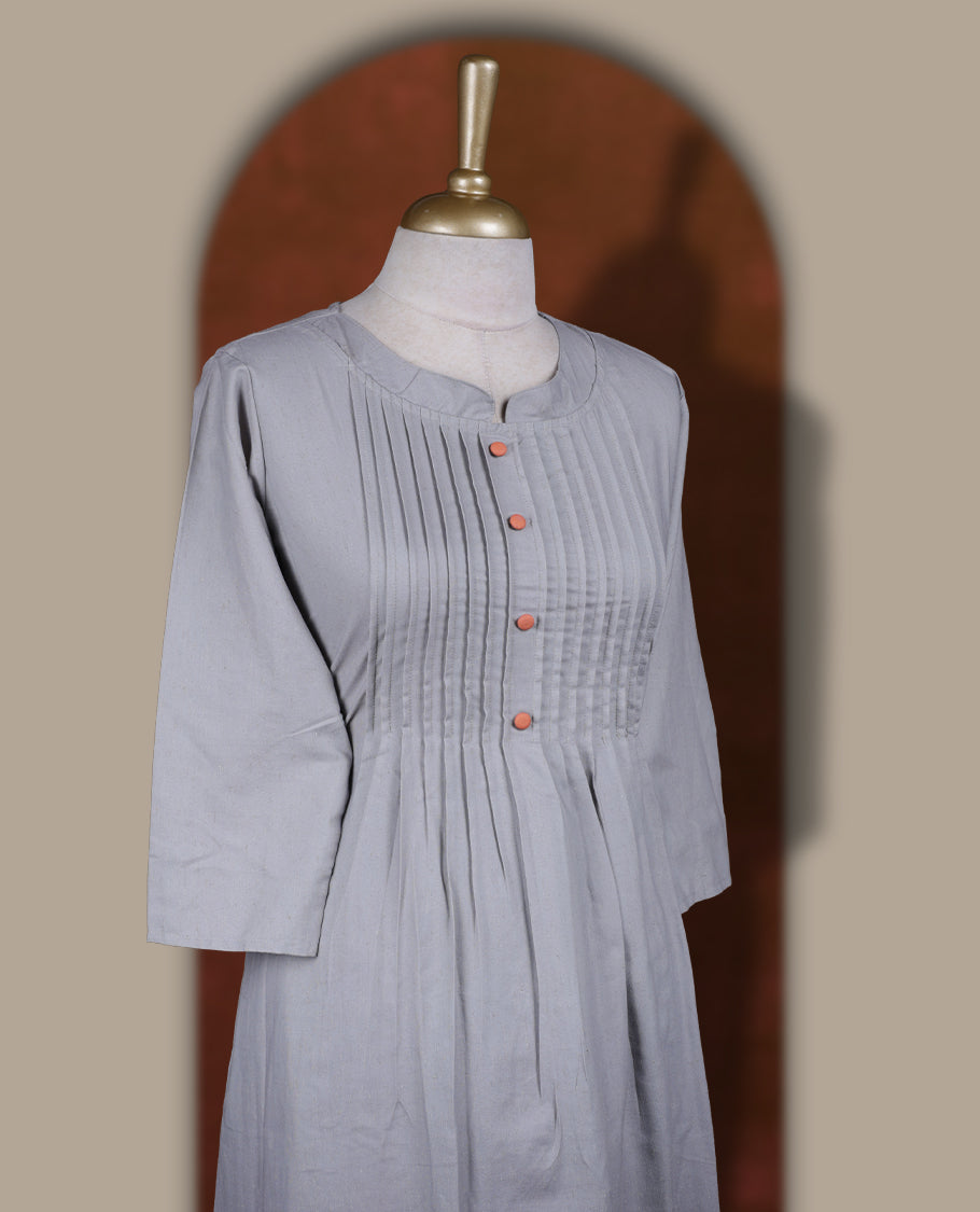 Grey colour coord set featuring a round neck kurta with pintuck detailing and wooden buttons, enhanced with vibrant floral prints along the hemline, paired with matching bottoms.