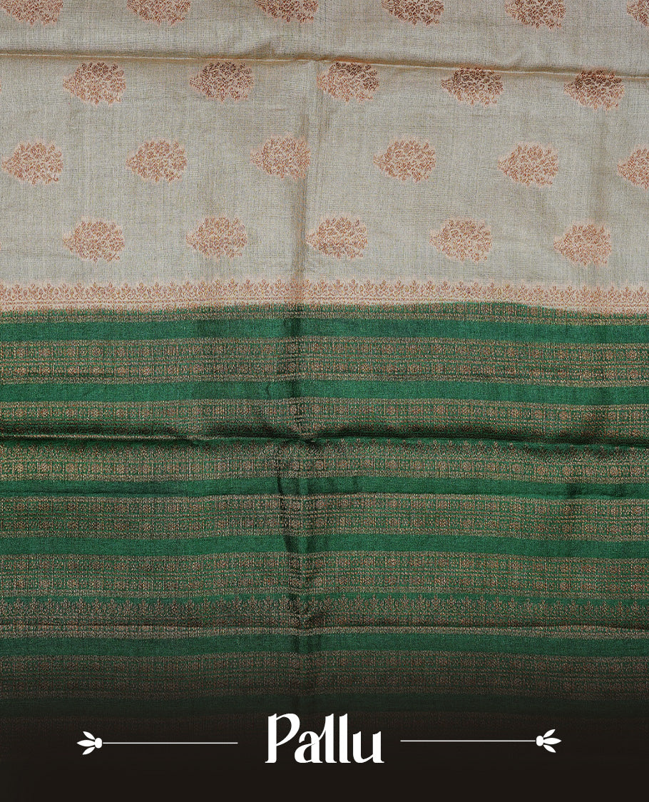 Golden Cream Colour Banaras tussar silk saree featuring Antique zari Motifs on body, Complemented by green colour variant with zari border, paired with matching blouse Piece.