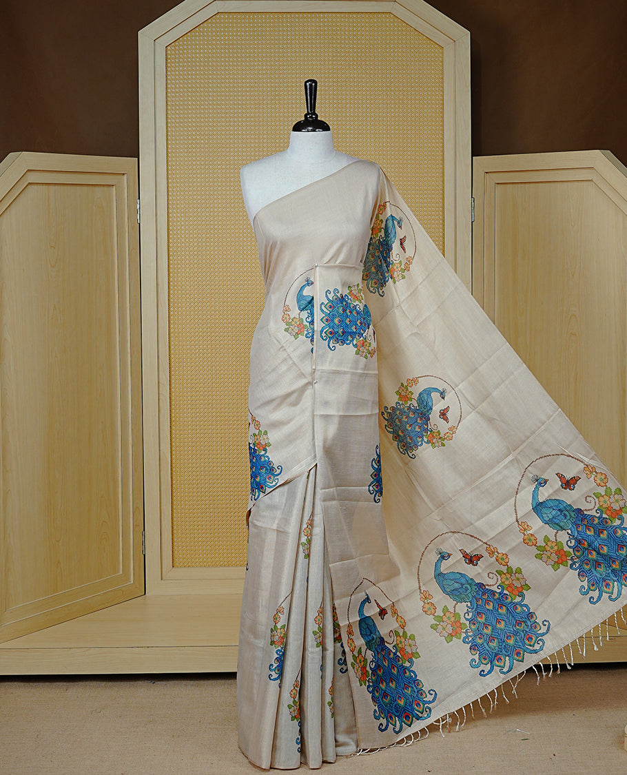 Light Gold colour semi tissue silk saree featuring Digital Peacock print motifs on body and border, paired with matching blouse piece.