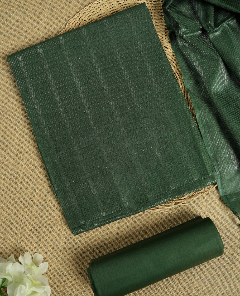 Steel green colour Tussar suit material adorned with intricate silver woven patterns and subtle motifs, exuding ethnic elegance & Paired with a beautifully bordered dupatta and a matching plain bottom.