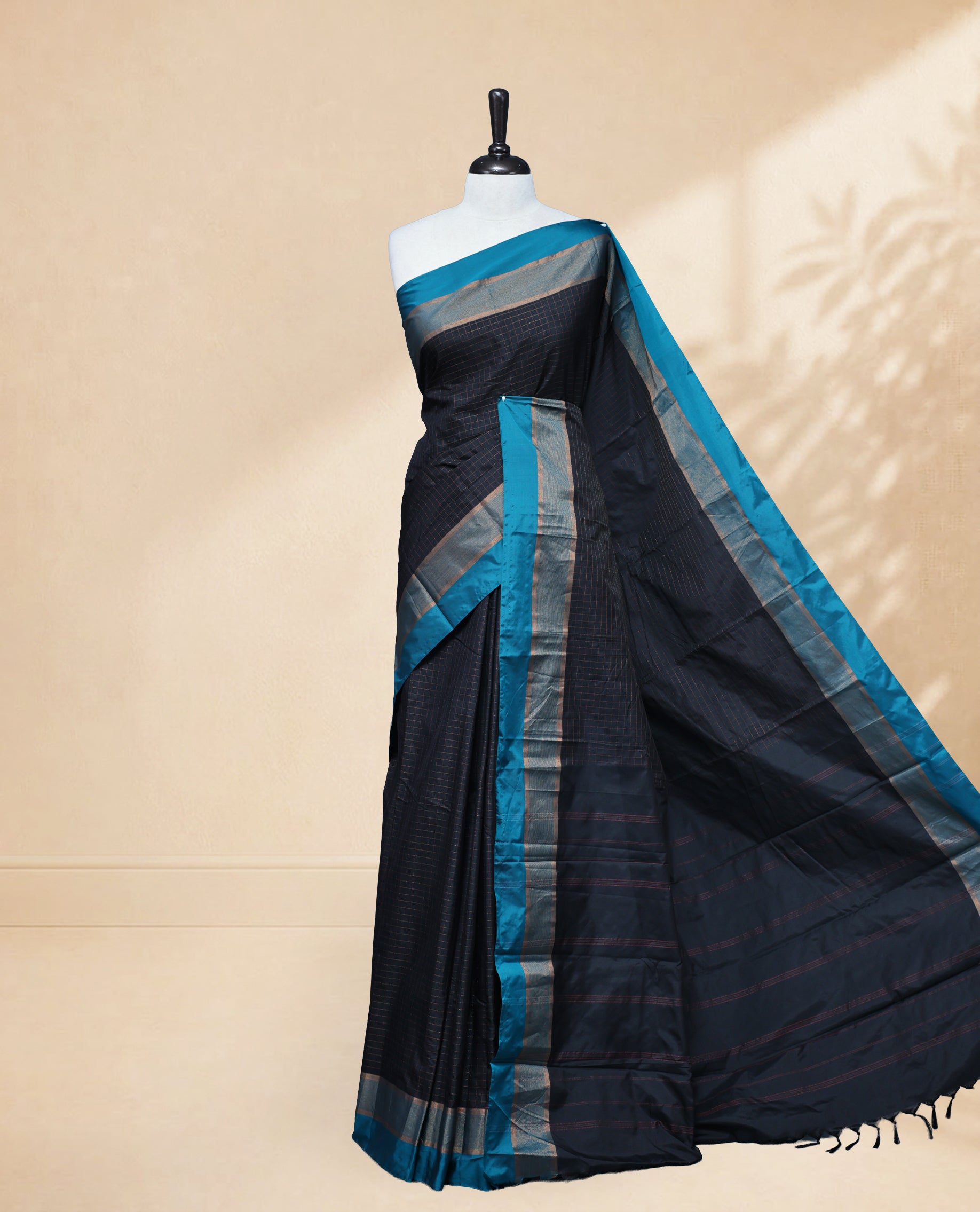 Dark Blue colour Semi Silk Saree Featuring Gold zari Small Checks on body, complemented by Contrast Border Detailing, comes with matching blouse piece.