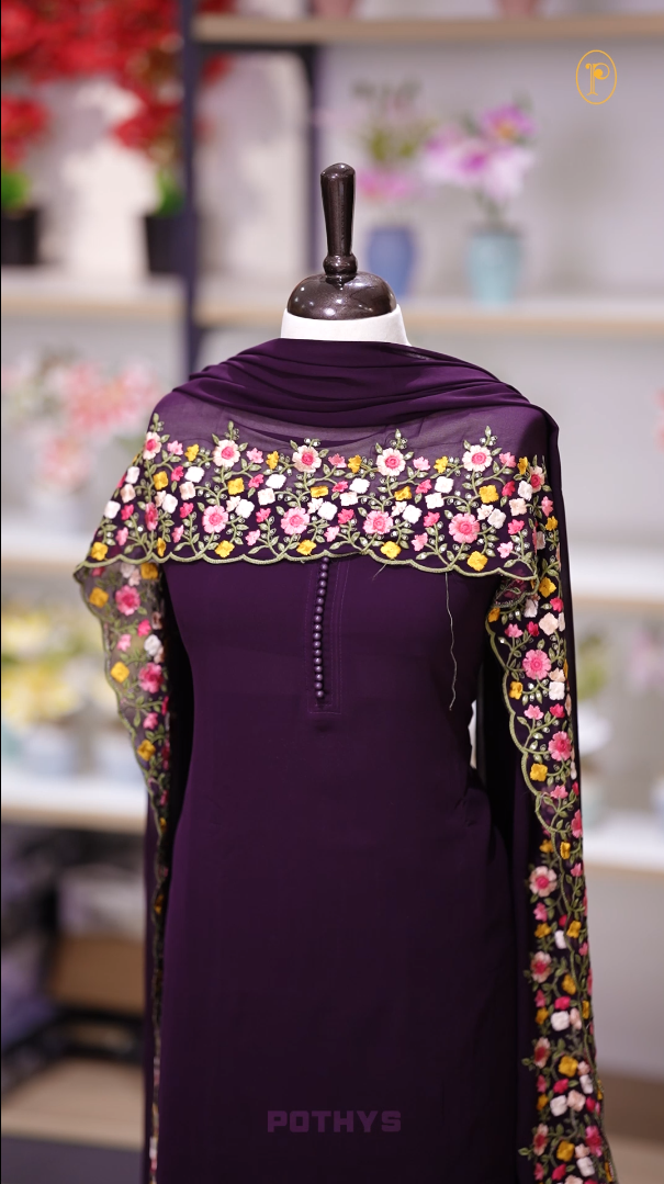 Wine colour Chiffon churidhar material featuring a plain top adorned with delicate beads work on the neckline, paired with a plain bottom, Highlighted by a dupatta with floral embroidery, sequins, and scalloped edges.