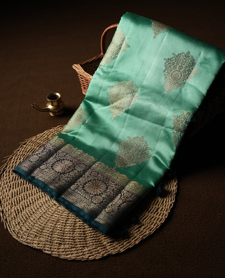 Mint Green Colour Banaras Soft Silk Saree with Gold Zari Diamond Leaf Buttas, Intricate Multi-Layered Floral Border, Grand Pallu with Ornate Sunflower Motifs in Dark Green and Gold Tones, and Matching Teal Blouse.