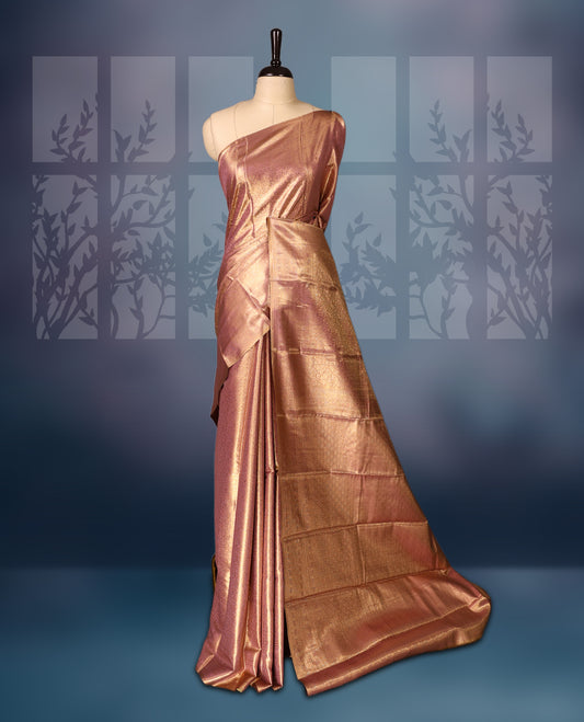 Golden pink colour semi silk brocade saree featuring delicate self brocade motifs across the body, enhanced with a soft gold toned woven border and pallu, Includes a matching blouse for a graceful ethnic look.