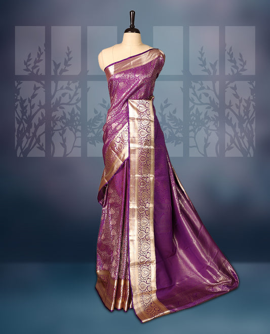 Purple semi silk brocade saree with rich gold zari brocade work all over, complemented by an intricately woven gold border and pallu, Comes with a matching blouse for a grand traditional look.